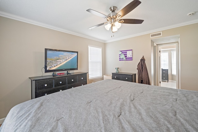 bedroom with ceiling fan, visible vents, and crown molding