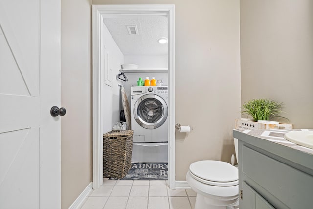 bathroom with visible vents, a textured ceiling, vanity, washer / dryer, and tile patterned floors