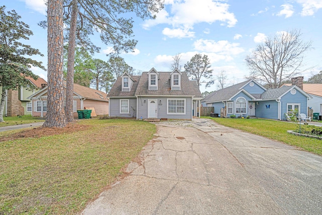 view of front of house featuring a front lawn and a shingled roof