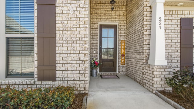 entrance to property with brick siding