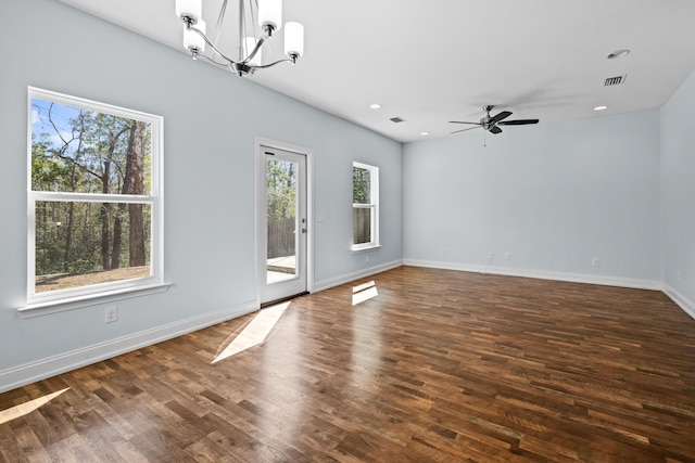 unfurnished room with baseboards, visible vents, dark wood-style flooring, and recessed lighting