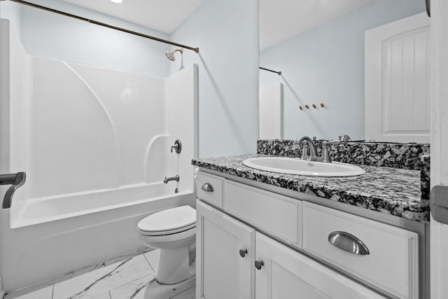 full bathroom with washtub / shower combination, marble finish floor, vanity, and toilet