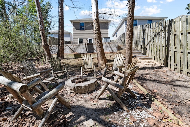 view of yard with an outdoor fire pit and a fenced backyard