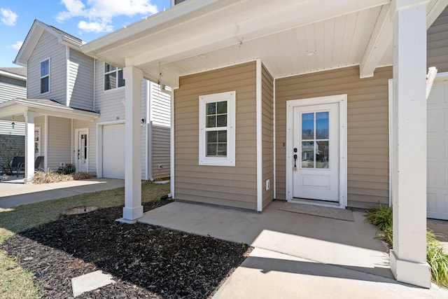 entrance to property with a garage and a porch