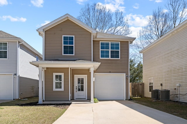 traditional-style house with a garage, concrete driveway, fence, and central AC unit