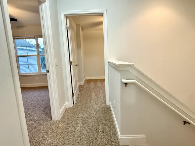 corridor featuring carpet and baseboards