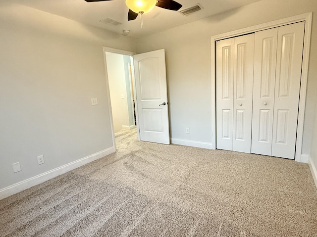 unfurnished bedroom featuring carpet, visible vents, and baseboards