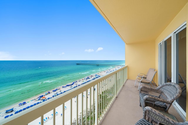 balcony with a water view and a beach view