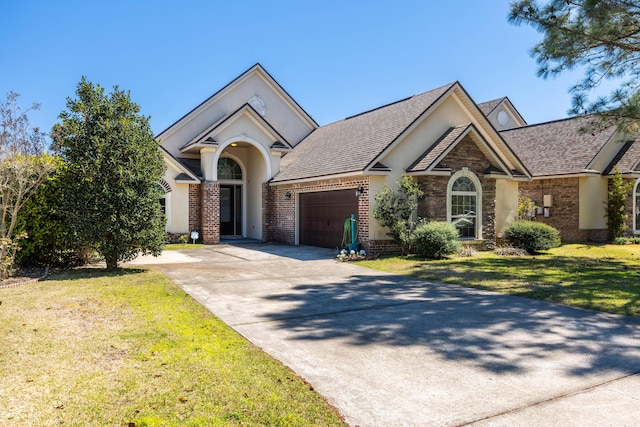 view of front of house featuring an attached garage, brick siding, concrete driveway, and a front yard