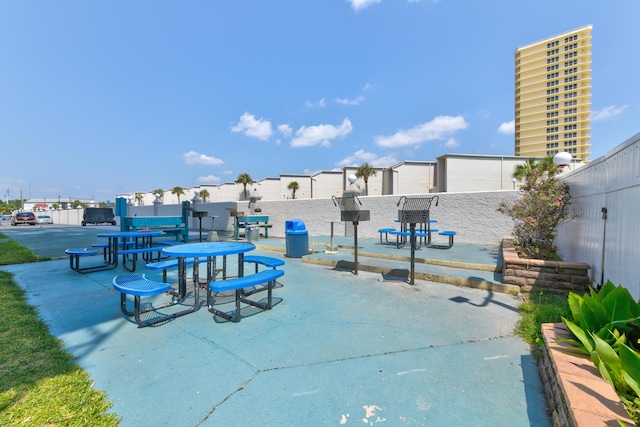 view of community with a patio and fence