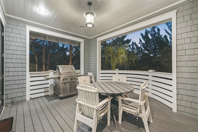 deck with outdoor dining space and grilling area