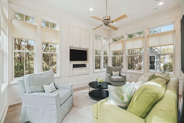 sunroom with a healthy amount of sunlight and ceiling fan