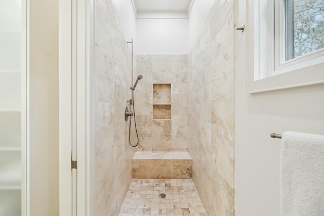 full bath with a tile shower and ornamental molding