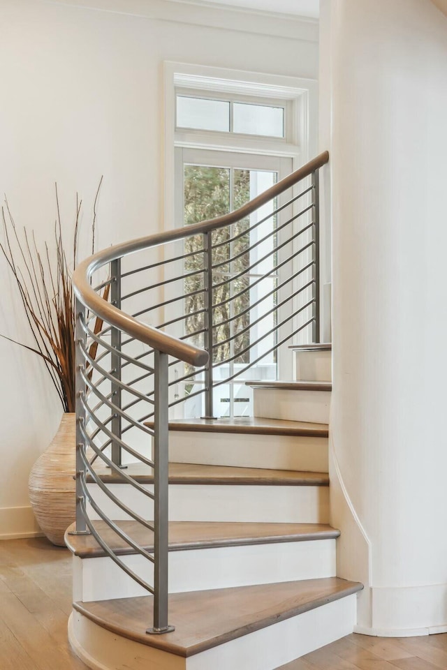 stairs with baseboards and wood finished floors