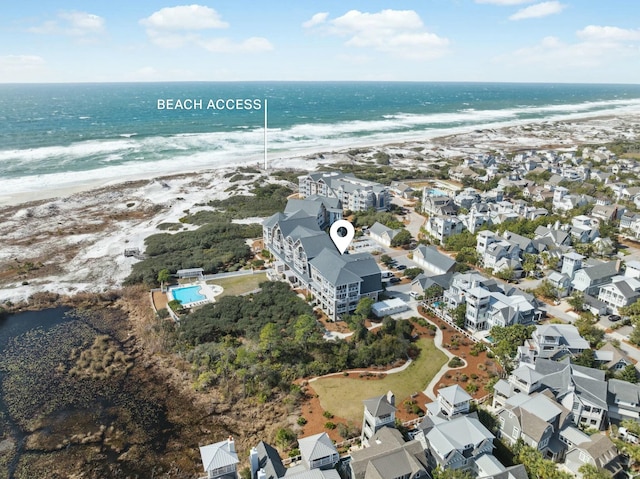 birds eye view of property featuring a view of the beach, a water view, and a residential view