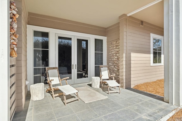 view of patio with french doors and visible vents