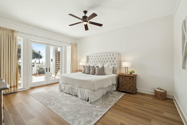 bedroom featuring access to exterior, baseboards, french doors, wood finished floors, and a ceiling fan