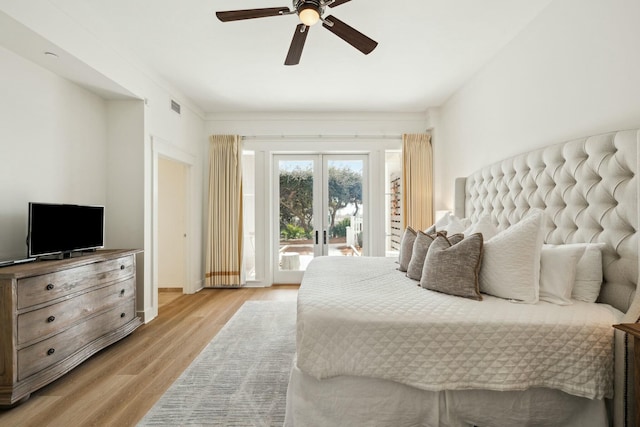 bedroom with a ceiling fan, visible vents, french doors, access to outside, and light wood-type flooring