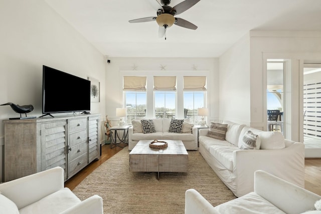 living room featuring a ceiling fan and wood finished floors