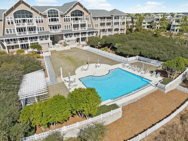 community pool featuring a patio and a fenced backyard