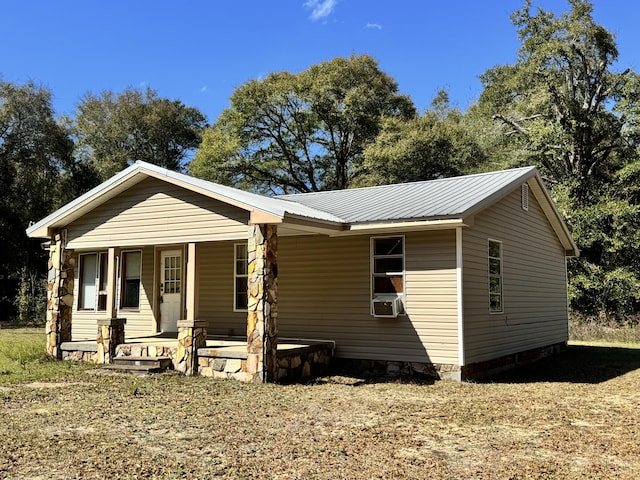 view of front of home featuring metal roof and a porch