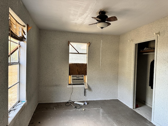 unfurnished bedroom with cooling unit and a ceiling fan