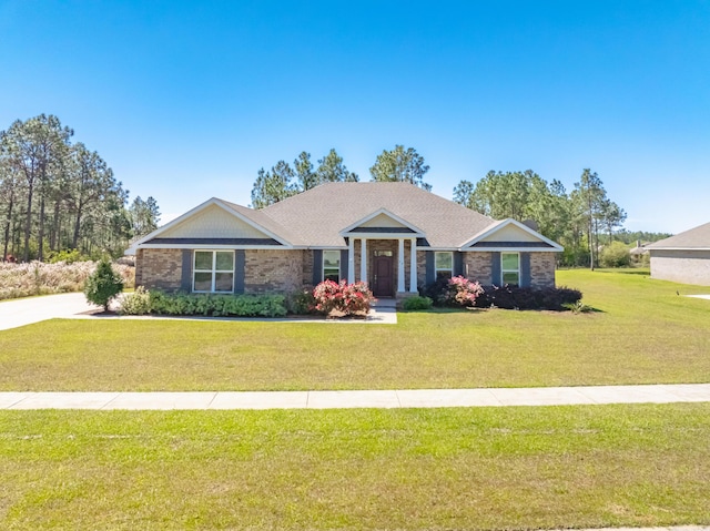 view of front of property with brick siding and a front yard