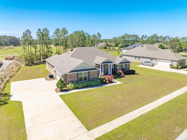 view of front of house featuring a garage, concrete driveway, a front lawn, and stone siding