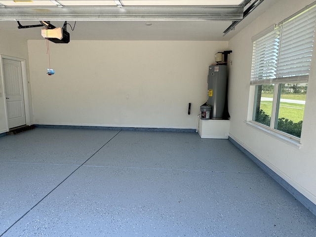 garage with water heater, baseboards, and a garage door opener