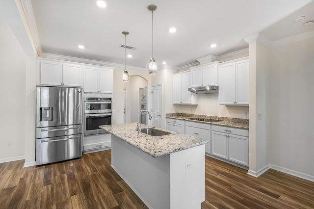 kitchen featuring arched walkways, under cabinet range hood, a sink, visible vents, and appliances with stainless steel finishes