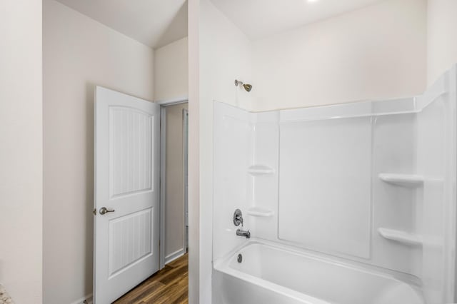 full bathroom with wood finished floors and bathing tub / shower combination