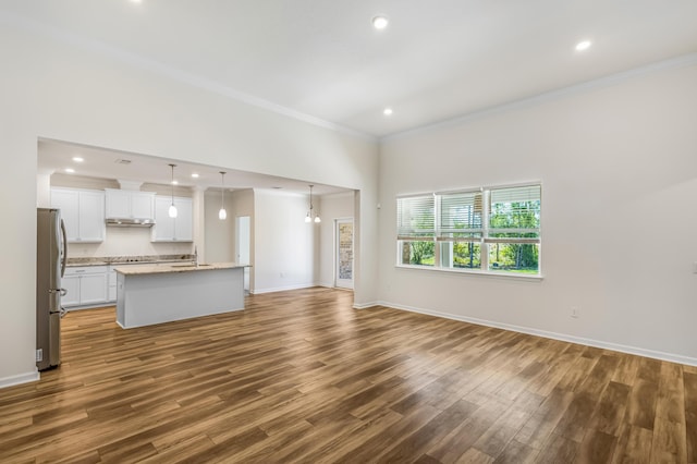 unfurnished living room featuring baseboards, ornamental molding, dark wood-type flooring, and recessed lighting