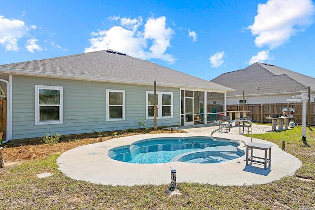 view of pool with a patio area, fence, and a sunroom