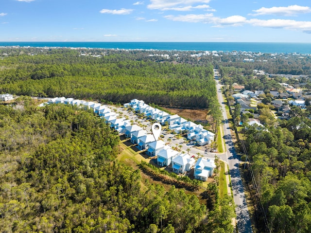 birds eye view of property with a forest view and a water view