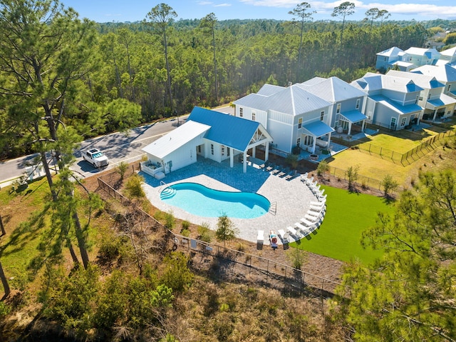 birds eye view of property featuring a view of trees