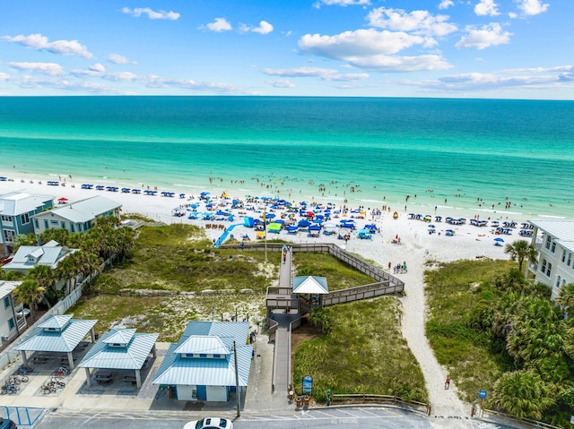 drone / aerial view featuring a water view and a view of the beach