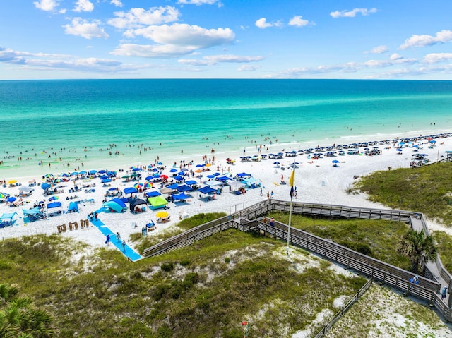 aerial view with a water view and a beach view