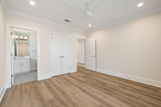 unfurnished bedroom featuring crown molding, light wood-style flooring, baseboards, and visible vents