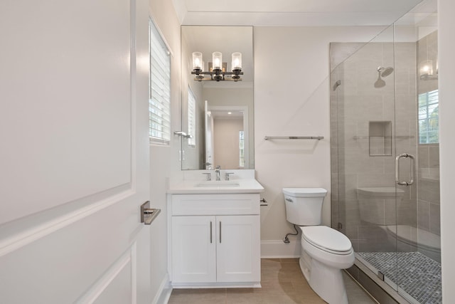 bathroom with baseboards, toilet, a stall shower, a notable chandelier, and vanity