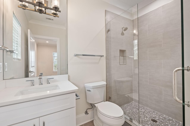 full bathroom featuring vanity, toilet, a stall shower, and ornamental molding