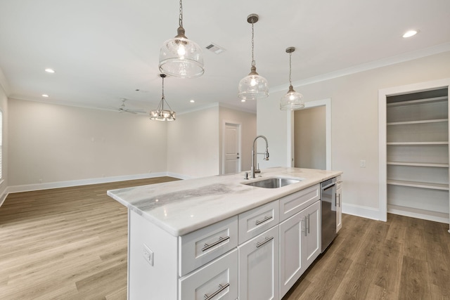 kitchen featuring ornamental molding, stainless steel dishwasher, light wood-style floors, and a sink