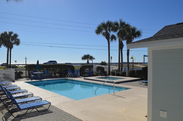 pool featuring a patio area, fence, and a community hot tub