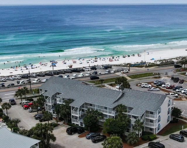 birds eye view of property featuring a water view and a view of the beach