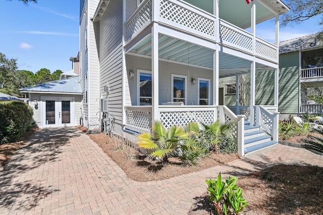 view of front of property featuring covered porch and french doors