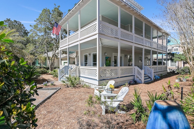 rear view of house featuring covered porch