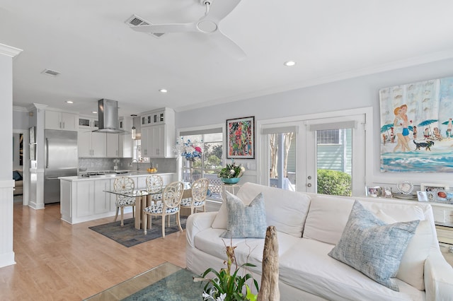 living room featuring visible vents, ceiling fan, ornamental molding, french doors, and light wood-style floors