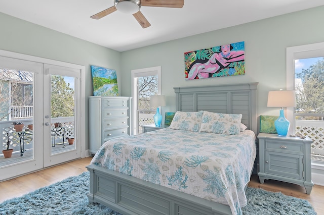 bedroom featuring french doors, light wood-type flooring, a ceiling fan, and access to exterior