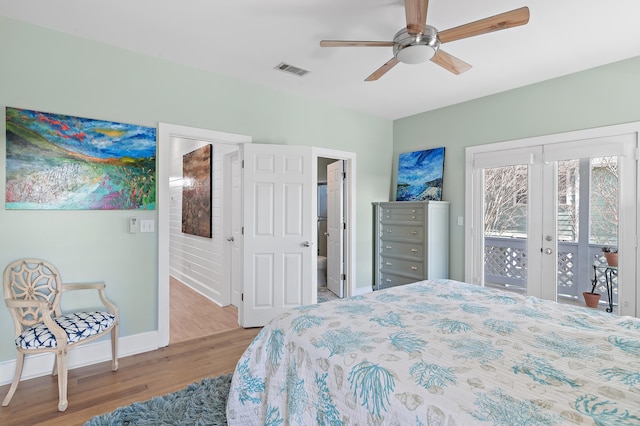 bedroom featuring wood finished floors, visible vents, baseboards, access to outside, and french doors