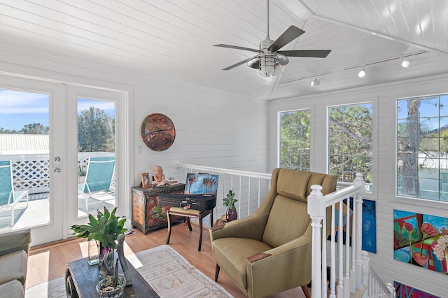 sunroom featuring vaulted ceiling, a ceiling fan, and french doors