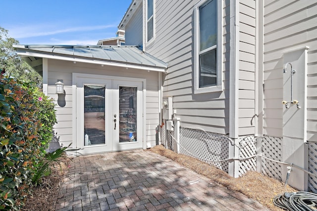 doorway to property with metal roof, french doors, and a standing seam roof